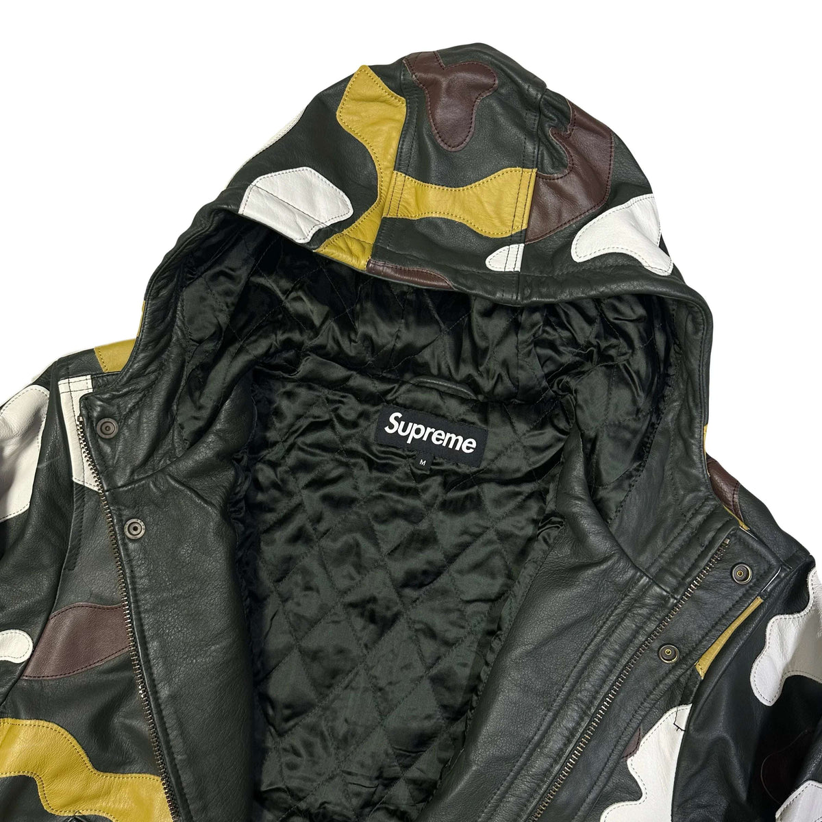 Interior view of a Supreme FW19 camo hooded leather jacket featuring a quilted lining.