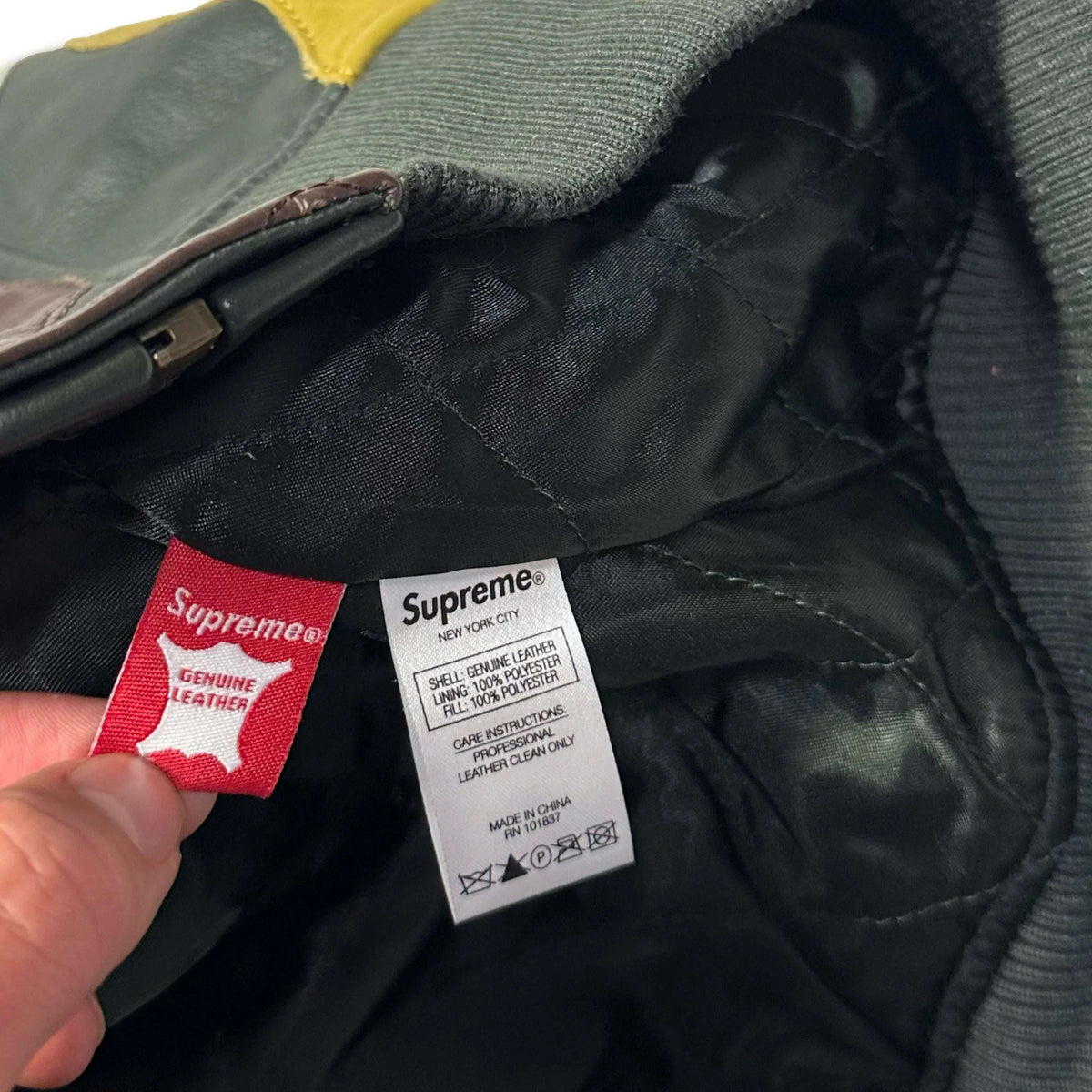 Close-up of the internal care and authenticity labels of a 1036 Emporium leather jacket.